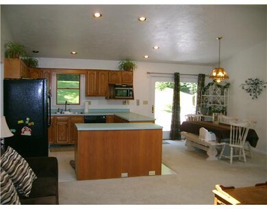 Kitchen open to living room and dining room with r