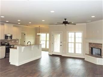 Great open floor plan with corner fireplace, vinyl