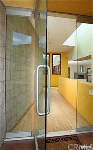 Entry features a large clear glass door ...