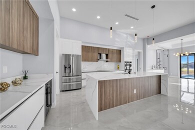 Kitchen featuring brown cabinetry, light stone counters, decorative light fixtures, and recessed lighting