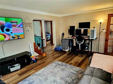 Office area with dark wood-type flooring and crown molding