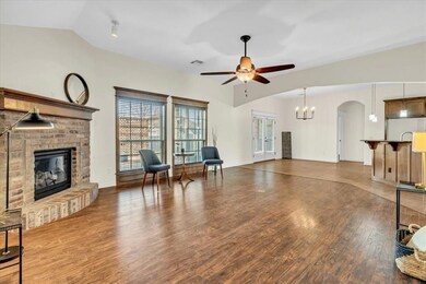 Living room engineered wood floors, a brick firepl