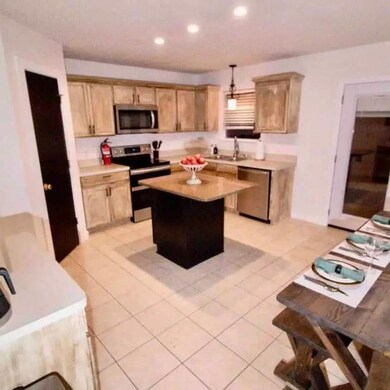 Kitchen with a kitchen island, appliances with sta