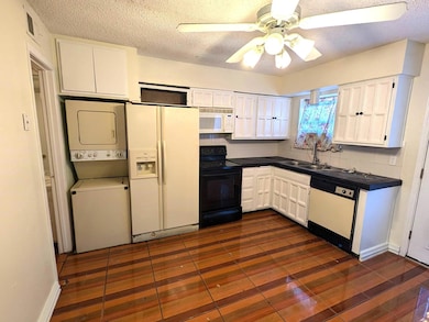 Kitchen featuring stacked washer and clothes dryer
