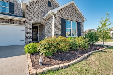 View of front of home featuring brick siding and a