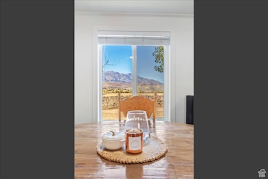 Dining room featuring a mountain view, ornamental molding, and wood finished floors