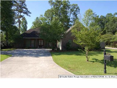 Wide driveway, with extra parking at left.