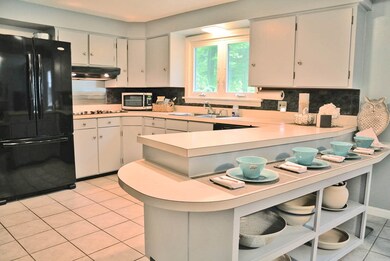 The wonderful  spacious kitchen will seat your guest with overflow to the dining room located immediately off the kitchen and opens  evenly to the family living space.  The wood stove fireplace is enjoyed by both spaces making it warm and inviting