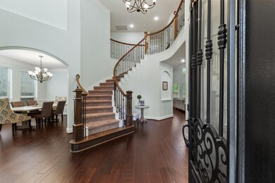 This elegant entryway features a grand, curved sta