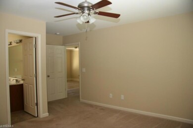 Master bedroom with ceiling fan and full bath.
