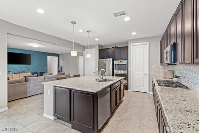 Kitchen featuring stainless steel appliances, dark