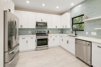 Kitchen featuring stainless steel appliances, lig