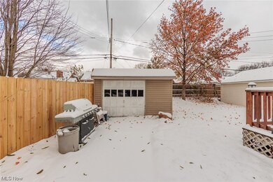 Snow covered structure featuring a garage