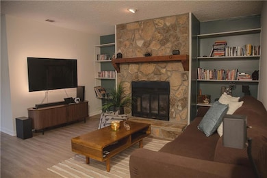 Living room with a textured ceiling, wood finished