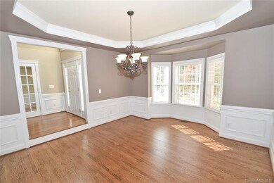 Large Dining room w/refinished hardwoods & bay win