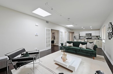 Living room featuring dark wood-style floors, fre