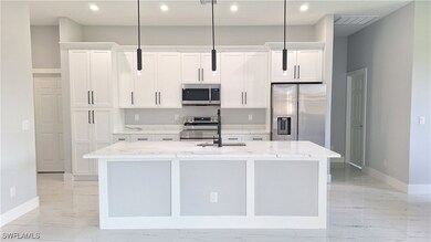 Kitchen featuring stainless steel appliances, base