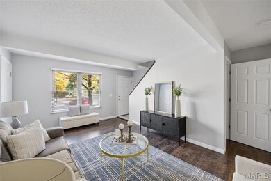 Living area featuring wood finished floors and a textured ceiling