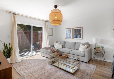 Living area with wood finished floors and baseboa