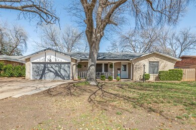 View of front of house featuring a porch, an attac