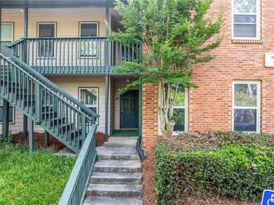 View of exterior entry featuring brick siding