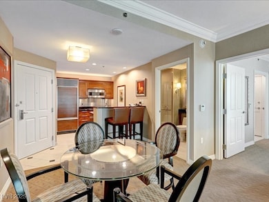 Dining space with light carpet and crown molding