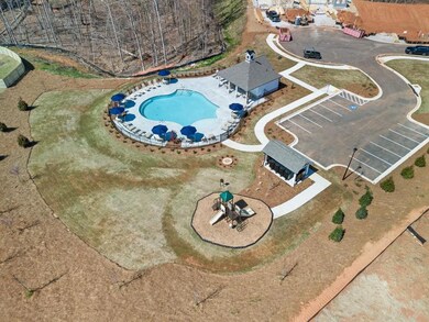 Aerial view of property and surrounding area with a pool area