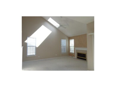 Living room with cathedral ceiling and gas firepla