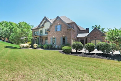 View of front facade featuring brick siding, a front yard, and a chimney