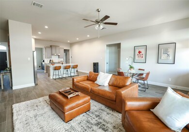 Living room with wood-type flooring and ceiling fa