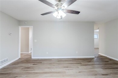Unfurnished room featuring ceiling fan and light wood-type flooring