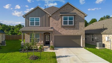 This photo shows a modern two-story brick home wit