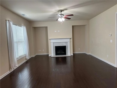 Unfurnished living room featuring a fireplace, vis