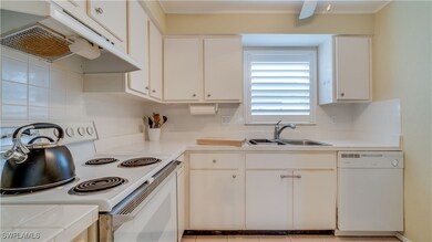 Kitchen featuring sink, white appliances, white ca