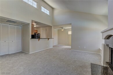 Unfurnished living room featuring a high ceiling,
