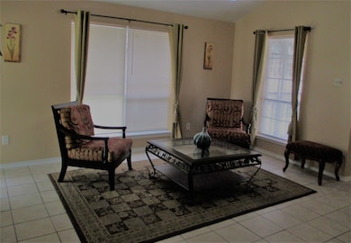 Relax in this spacious living room with natural lighting, fresh paint tones and tile flooring throughout. Gas fireplace and bookshelves for those quite moments.