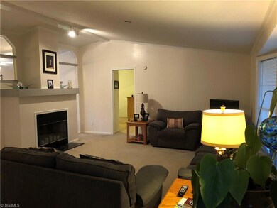 From the front entrance you enter the living room which is divided by the fireplace. The far doorway is the master suite.