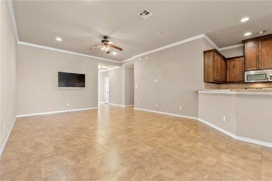 Unfurnished living room featuring ornamental moldi