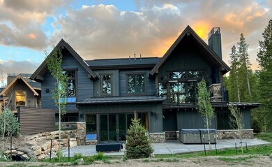 Back of property at dusk with a patio, a chimney,