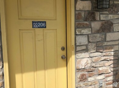 Entrance to property featuring stone siding