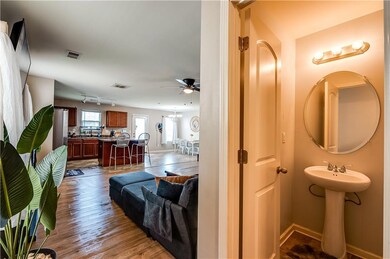 Bathroom with wood finished floors and ceiling fan