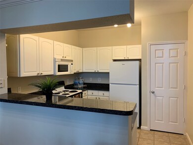 Nice size kitchen with breakfast bar.