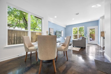 Dining space with concrete floors and recessed li