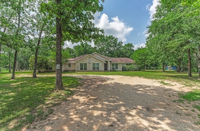This photo shows a charming single-story home surr