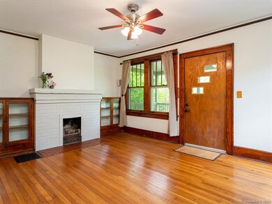 Period fireplace and built-ins are highlights of the living room.