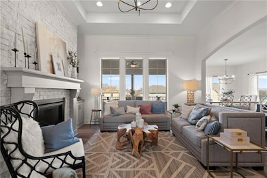 Great Room with windows - Photo from a previous model.