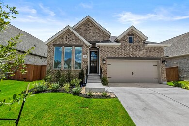 View of front of property with a garage, brick si