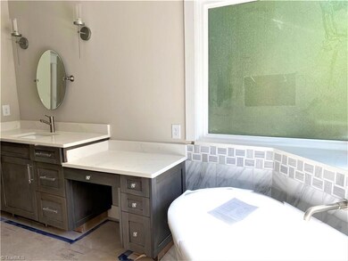 The master bath has a separate extra deep tub, custom shower and his and her vanities.