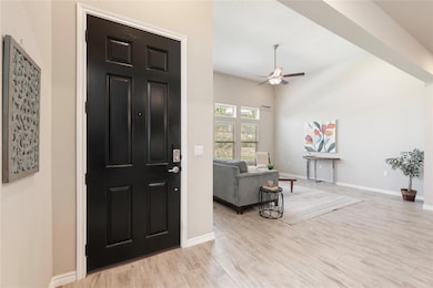 Entrance foyer with ceiling fan and wood finished