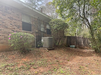 View of yard featuring central AC and fence